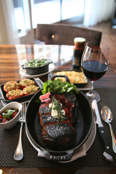 Strip Steak with Sides Roasted 1 Tomatoes, Creamed Spinach